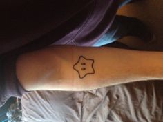 a person with a star tattoo on their arm