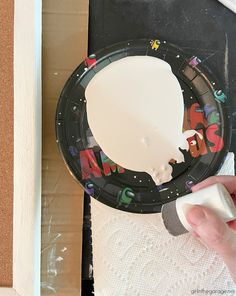 someone is painting the inside of a paper plate