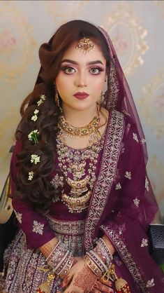 a woman wearing a purple bridal outfit