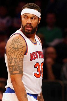 a basketball player with tattoos on his arm