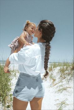 Mother and baby enjoying the beach with a long braid hairstyle Beach Photos With Baby, Mom And Baby Beach Photos, Romanticizing Motherhood, Beach Pictures With Baby, Mommy And Me Beach Photo Shoot, Beach Mom Aesthetic, Babies At The Beach, Hair Braiding Ideas, Toddler Beach Photos