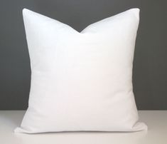 a white pillow sitting on top of a table