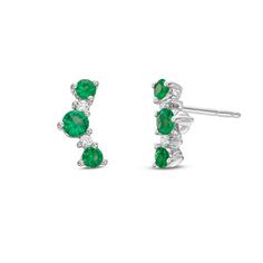 These delicate stud earrings feature emeralds totaling 0.56 carats and round brilliant cut diamonds totaling 0.05 carats. Green Brilliant Cut Diamond Earrings, Classic Green Diamond Earrings, Green Diamond Earrings With Prong Setting, Green Diamond Earrings Fine Jewelry, Fine Jewelry Green Diamond Earrings, Green Diamond Earrings In Fine Jewelry Style, Anniversary Green Diamond Earrings, Green Diamond Earrings With Diamond Accents, Green Pave Setting Fine Earrings