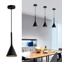 three lights hanging from the ceiling above a dining room table