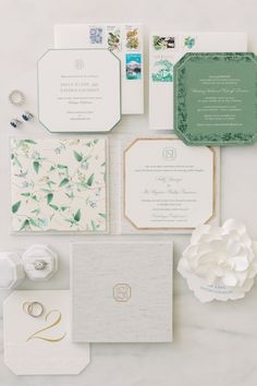 the wedding stationery is laid out on top of each other