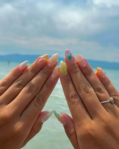 A stunning display of pastel hues reminiscent of a day at the beach, featuring delicate seashell and starfish designs. Soft blues, pinks, and yellows blend seamlessly, creating an ethereal, ocean-inspired look. The intricate 3D art adds dimension, while the glossy oval shape enhances the whimsical feel, making this perfect for summer seaside adventures.@nailsby._kate Yellow Beach Nails, Summer Nails For The Beach, Ethereal Ocean, Ocean Nails, Seashell Nails