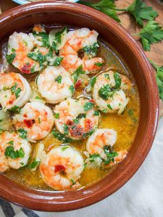 a bowl filled with shrimp and vegetables on top of a table