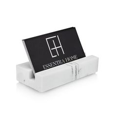 a black and white business card holder with the word essenra home on it's front