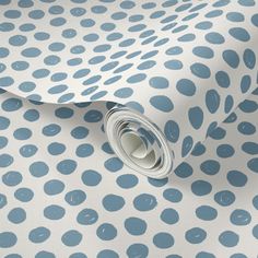 a blue and white polka dot wallpaper with circles on it's back ground