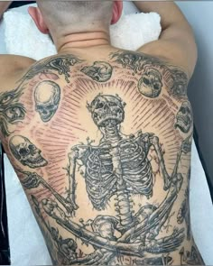 a man with a skeleton tattoo on his back