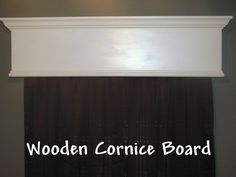 the word wooden corince board is displayed above a window with drapes on it