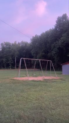 a swing set in the middle of a field