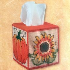 a cross stitch tissue box with a pumpkin and sunflower on it