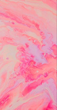 pink and white fluid paint with lots of bubbles on the surface, as seen from above