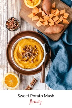 sweet potato mash with oranges and nuts on a cutting board next to it