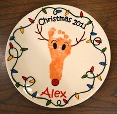 a plate with a handprinted christmas ornament on it that says,'christmas 2011 alex '