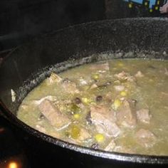 a pot filled with soup sitting on top of a stove