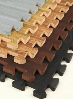 several pieces of wood are arranged on top of each other with different colors and shapes