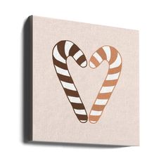 two candy canes in the shape of a heart on a beige background canvas wall art print