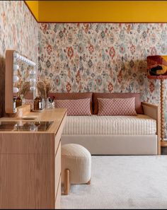 a living room filled with furniture and wallpaper covered in colorful flowers on the walls