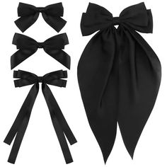 three pieces of black satin bow ties and two different styles of hair clips on white background