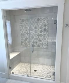 a walk in shower sitting next to a white wall and floor covered in tile tiles