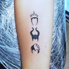 a tattoo on the arm of a woman with an image of two birds and a crown