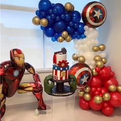 balloons and decorations are arranged in the shape of captain america, iron man, and spider - man