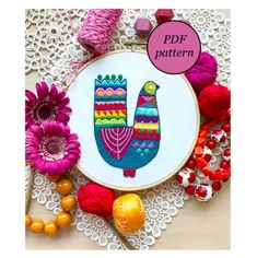 a colorful hand embroidery pattern on a doily surrounded by crochet and beads