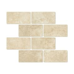 a white brick wall that has been made out of several different types of tiles on it