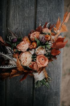 a bouquet of flowers with the words if you love the trending rust and orange color palette, this retro wolf feather honey arm wedding decoration is for you