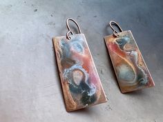 "Raku art-form hand enameled solid copper earrings. Length: 1 1/2\" I use the highest quality USA solid copper. Each copper piece is hand torched, and then enameled by hand with cold enameling in small batches. Through a special process, I mirror each pair of earrings to be complementary. I've been hand-torching metals for over two decades, perfecting the art of natural aging. Adding cold enameling has been a sheer delight. For these earrings, I used a combination of different cold enamels to ac Artistic Hand Painted Copper Earrings, Hand Painted Copper Artsy Earrings, Hand Painted Artsy Copper Earrings, Artsy Hand Painted Copper Earrings, Artistic Enamel Earrings, Hand Forged Jewelry, Cold Enamel, Natural Aging, Made Jewelry