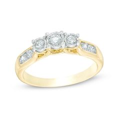 three stone diamond ring in yellow gold