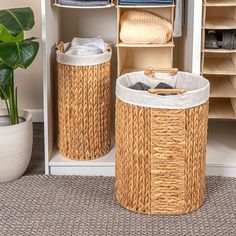 two wicker laundry baskets sitting next to each other in front of an open closet