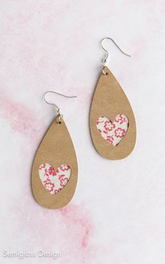 two pairs of earrings with hearts on them