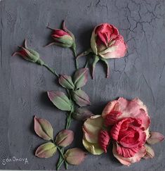 two pink flowers on a gray surface