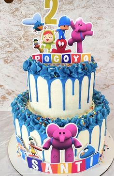 a birthday cake decorated with cartoon characters and numbers