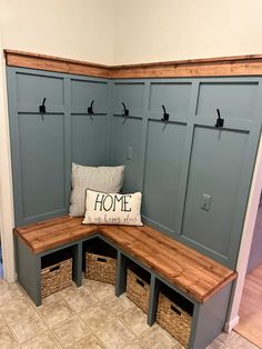 a corner bench with storage baskets underneath it