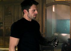 a man in black shirt holding a glove