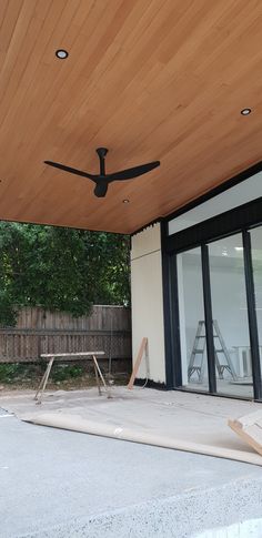 a ceiling fan sitting on top of a wooden roof