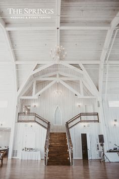 the inside of a large white building with stairs and chandelier