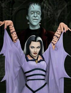 a woman dressed as dracula and a man in a costume with bats on their arms