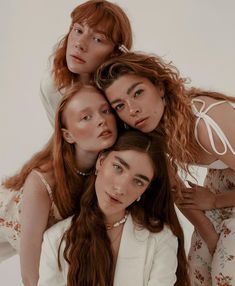 three women are posing for the camera with their arms around each other