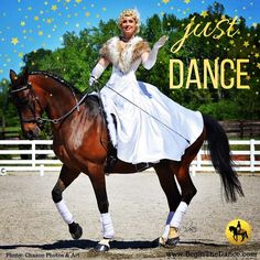 a woman in white dress riding on the back of a brown horse