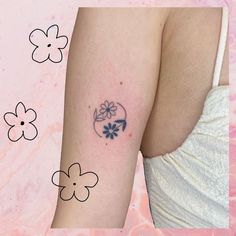 a woman with a flower tattoo on her arm