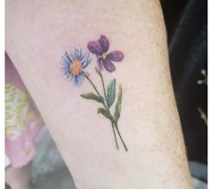 a small flower tattoo on the ankle