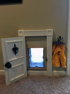 an open door to a small window in a room with carpeted floor and walls