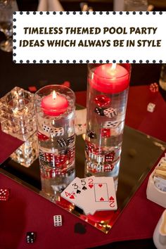 two candles and some dices on a table with poker cards in front of them