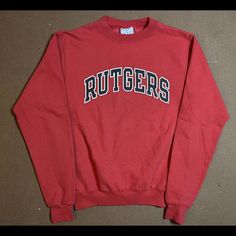 This Vintage Champion Sweatshirt Is A Must-Have For Any Rutgers University Fan. The Red Knit Cotton Blend Fabric Is Accented With The Iconic Rutgers Logo, Making It A Perfect Addition To Any 90s-Themed Outfit. The Sweatshirt Features A Classic Fit, Long Sleeves, And A Pullover Closure With A Crew Neck Neckline. The Sweatshirt Is Made With Breathable Materials, Making It Suitable For All Seasons. It's Great For Gym And Training Activities, As Well As Walking And Basketball. This Unisex Sweatshirt Retro Red Top With Ribbed Cuffs, Retro Red Cotton Sweatshirt, Red Retro Cotton Sweatshirt, Vintage Red Cotton Sweatshirt, Vintage Red Tops With Ribbed Cuffs, Vintage Red Top With Ribbed Cuffs, 90s Themed Outfits, Vintage Gym, Training Activities