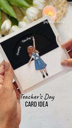 a person holding up a card that says teacher's day